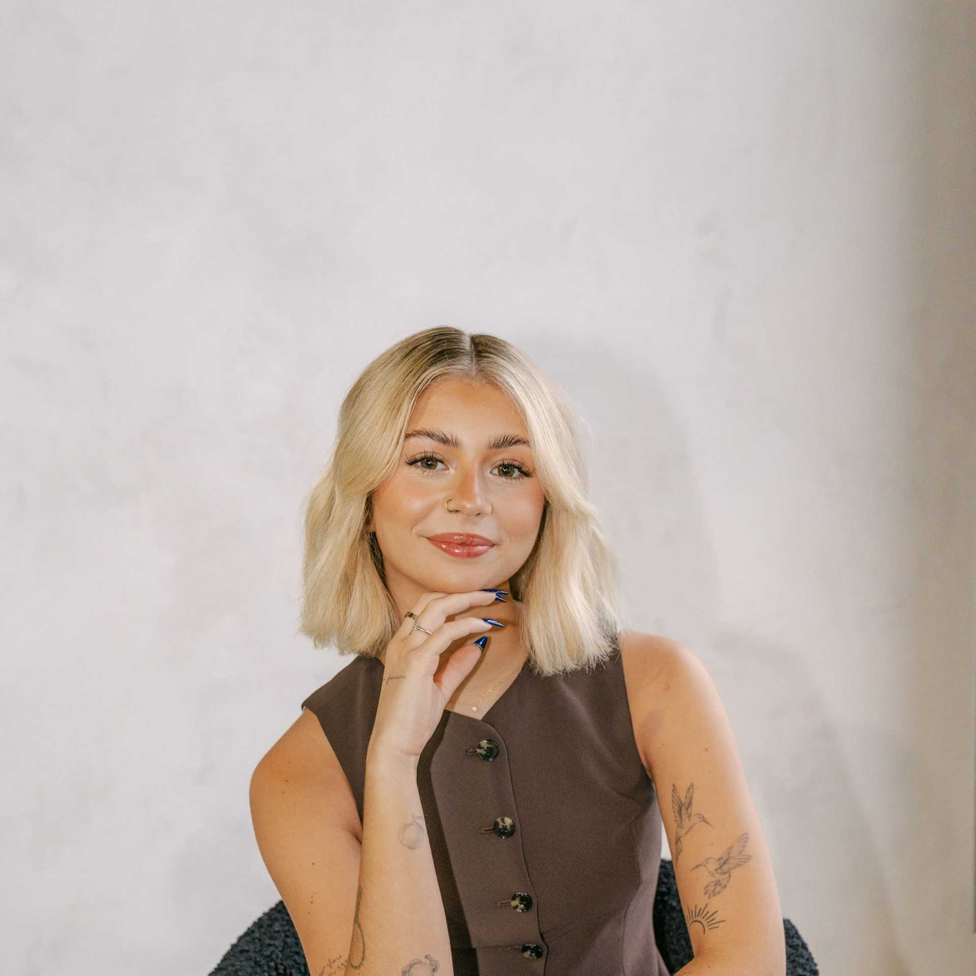 Portrait of Alivia Blakely, a professional stylist at Chromatique Salon, showcasing their expertise and style.