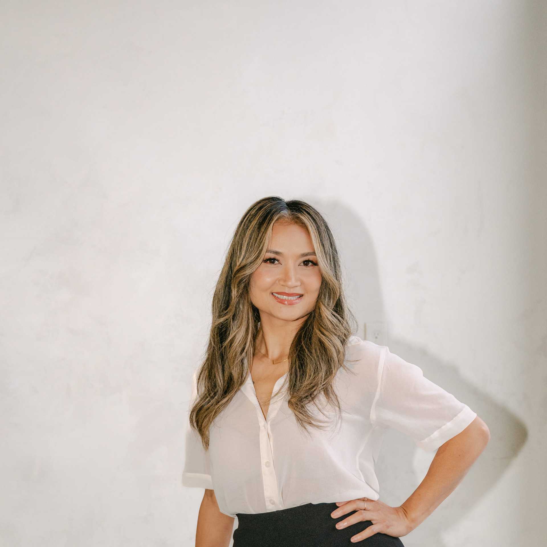 Portrait of Aretas Ho, a professional stylist at Chromatique Salon, showcasing their expertise and style.